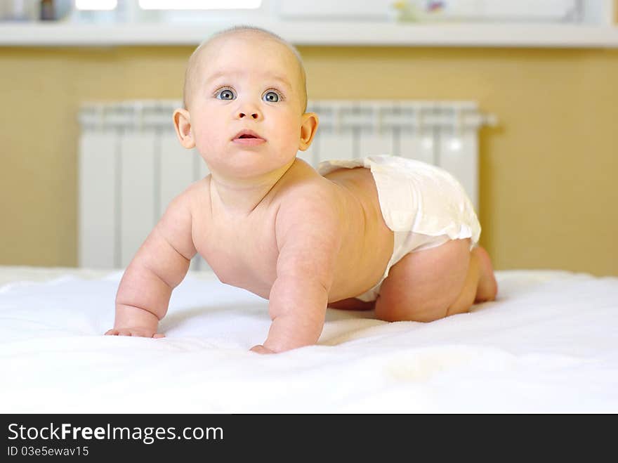 Happy baby girl on bed. Happy baby girl on bed.