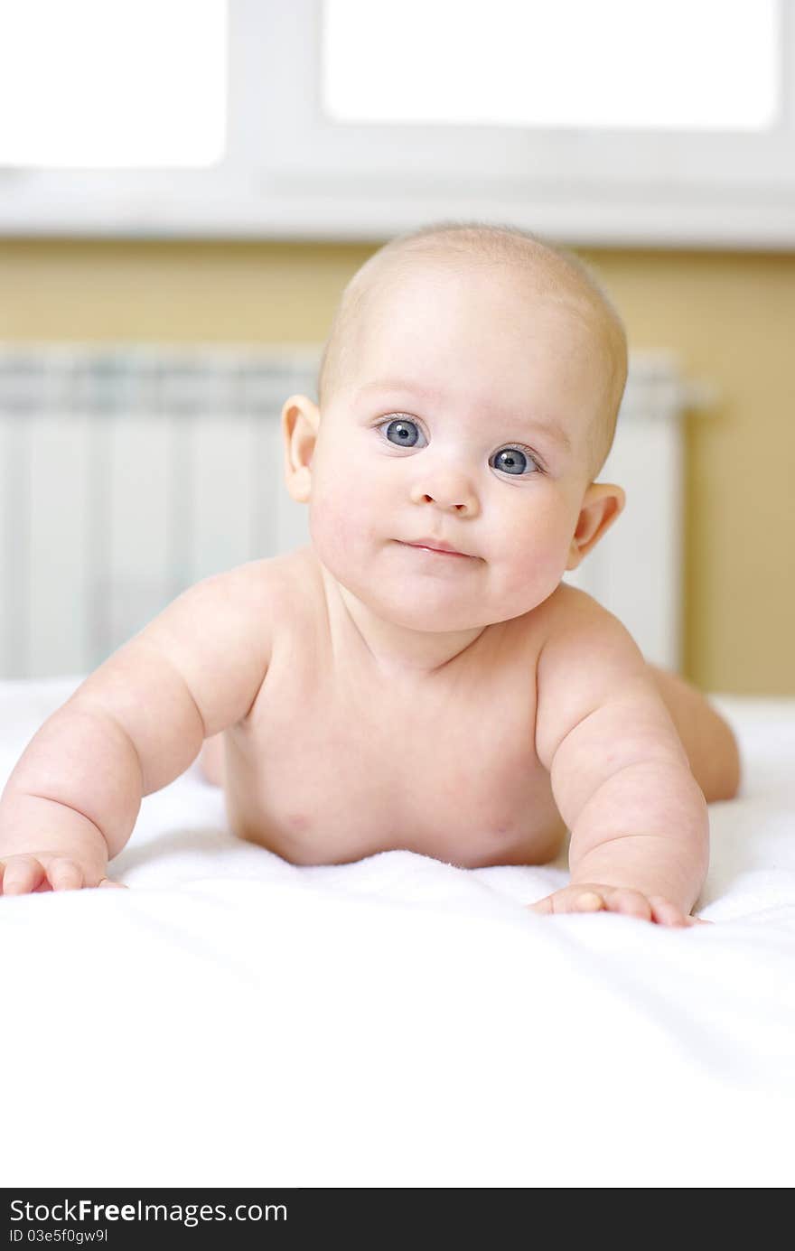 Happy baby girl on bed. Happy baby girl on bed.