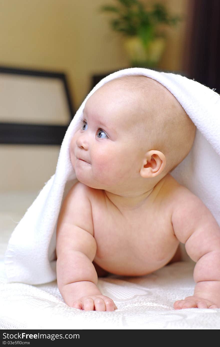 Happy smiling baby girl on bed after bath. Happy smiling baby girl on bed after bath.