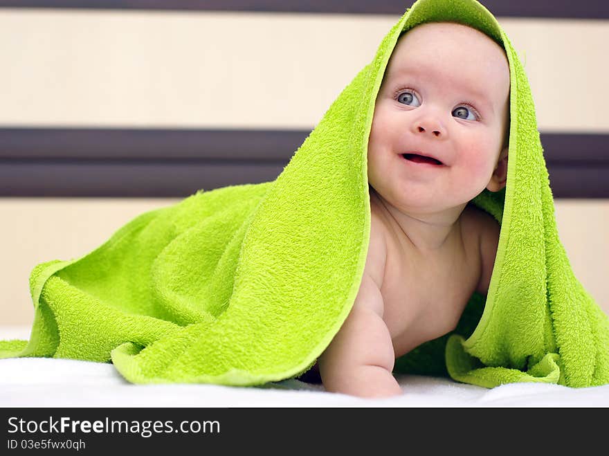 Happy smiling baby girl on bed after bath. Happy smiling baby girl on bed after bath.