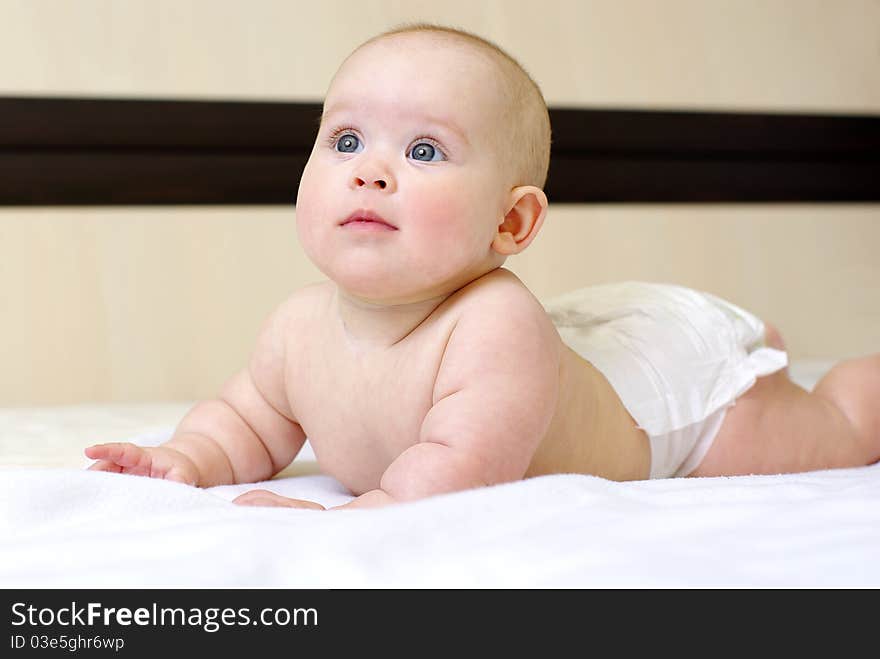 Happy  baby girl on bed. Happy  baby girl on bed.