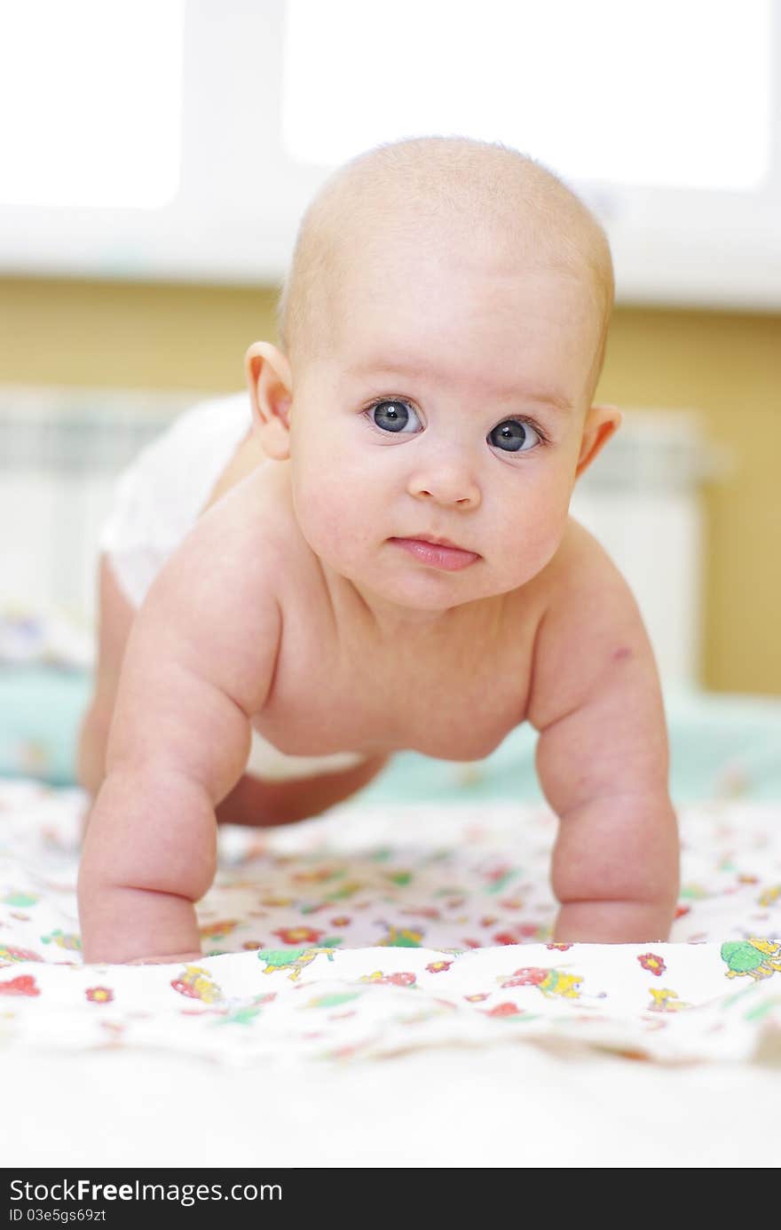 Happy baby girl on bed. Happy baby girl on bed.