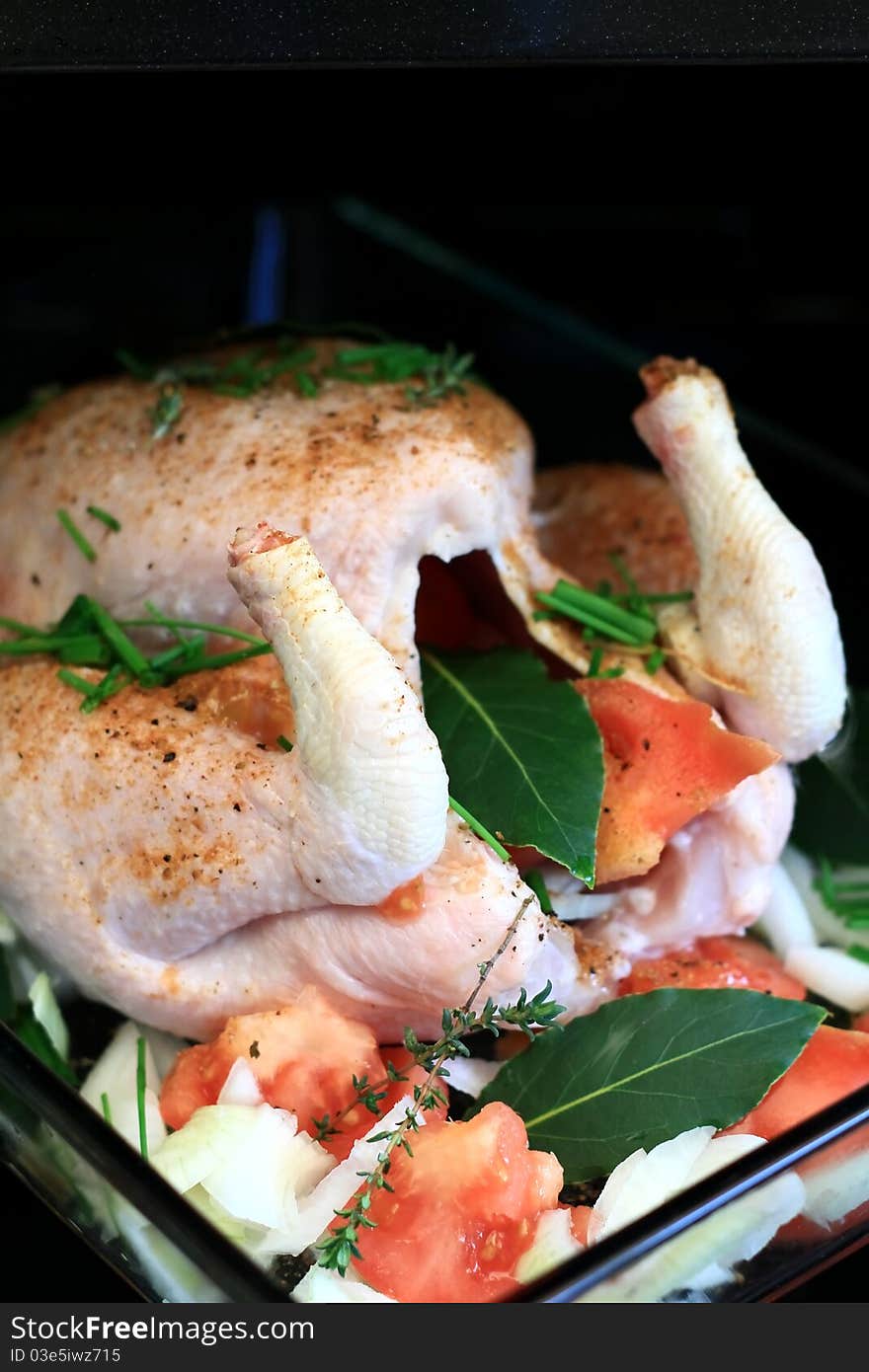 Image of a fresh seasoned chicken just before it goes into the oven