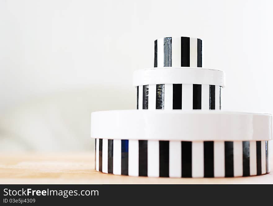 Tower of round boxes in black and white stripes. Tower of round boxes in black and white stripes