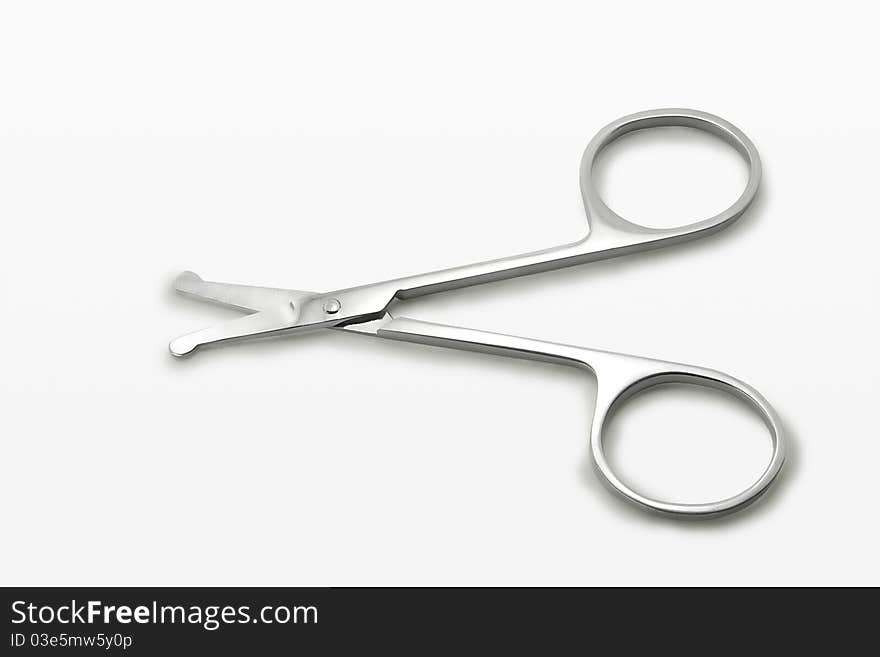 Small scissors on white background