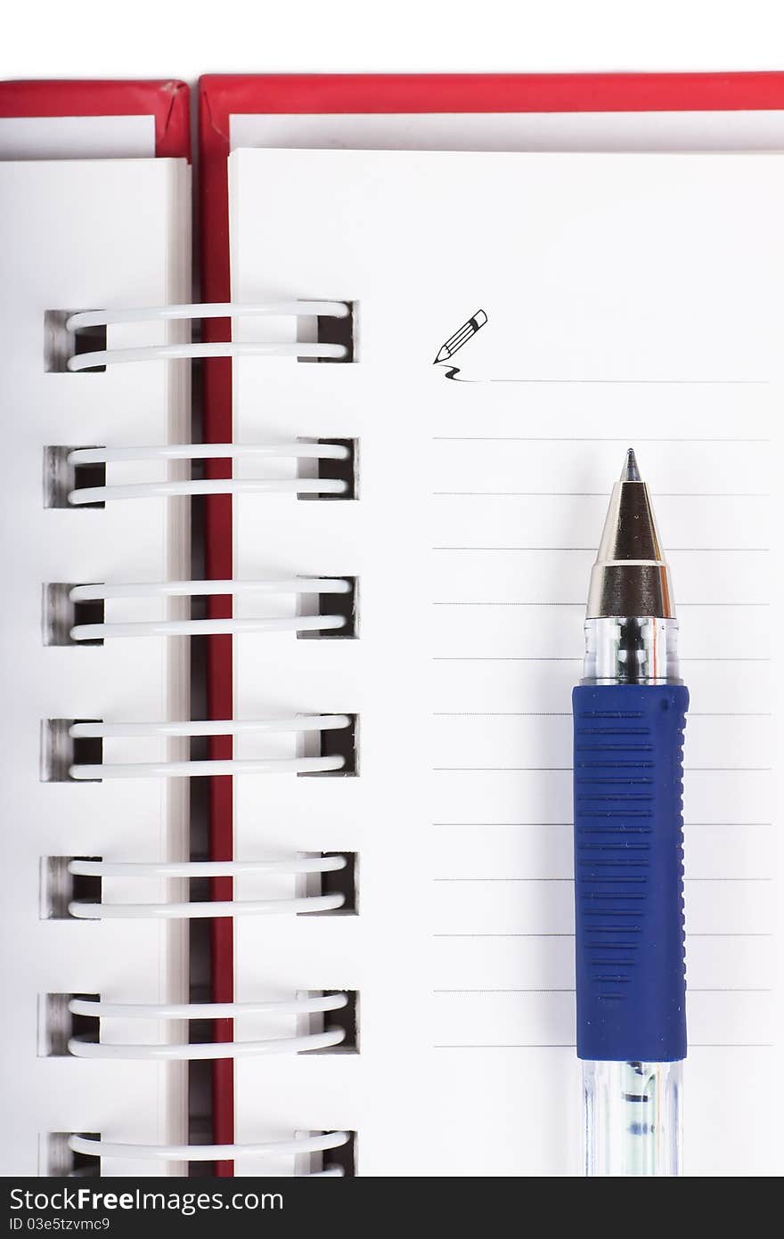 Macro view of blank spiral notebook and pen