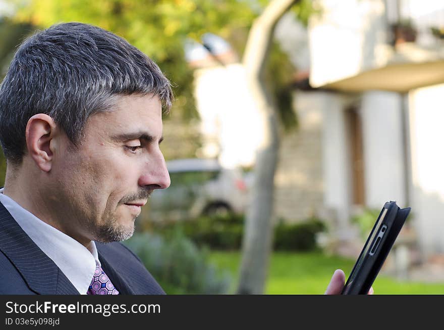 Business Man Working Outdoor with his Tablet