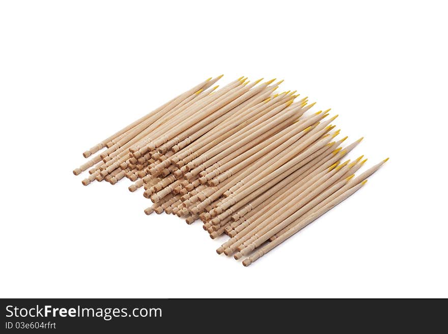 Wooden toothpicks with a yellow edge on a white background. Wooden toothpicks with a yellow edge on a white background