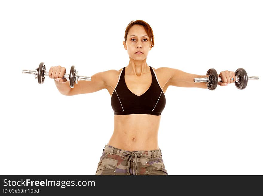 A woman is working out lifting the weights out with her arms. A woman is working out lifting the weights out with her arms.