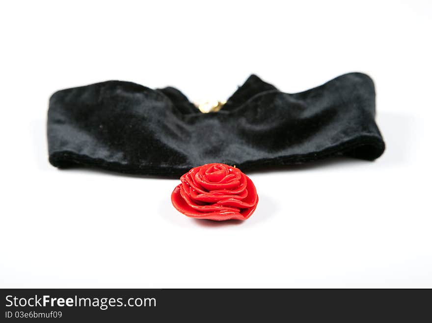 Necklace red rose on black velvet. Hand made from a plastic clay isolated on white background