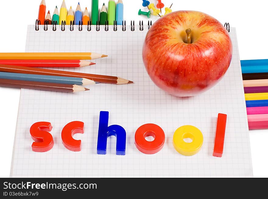 Pencils and apple - concept school on white