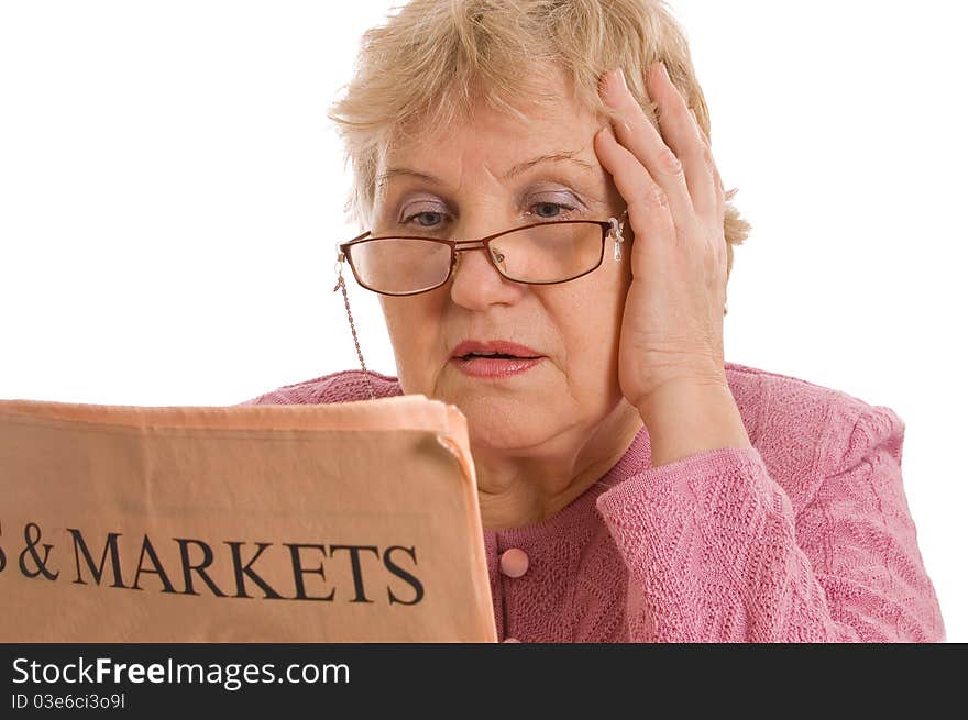 The elderly woman reads the newspaper