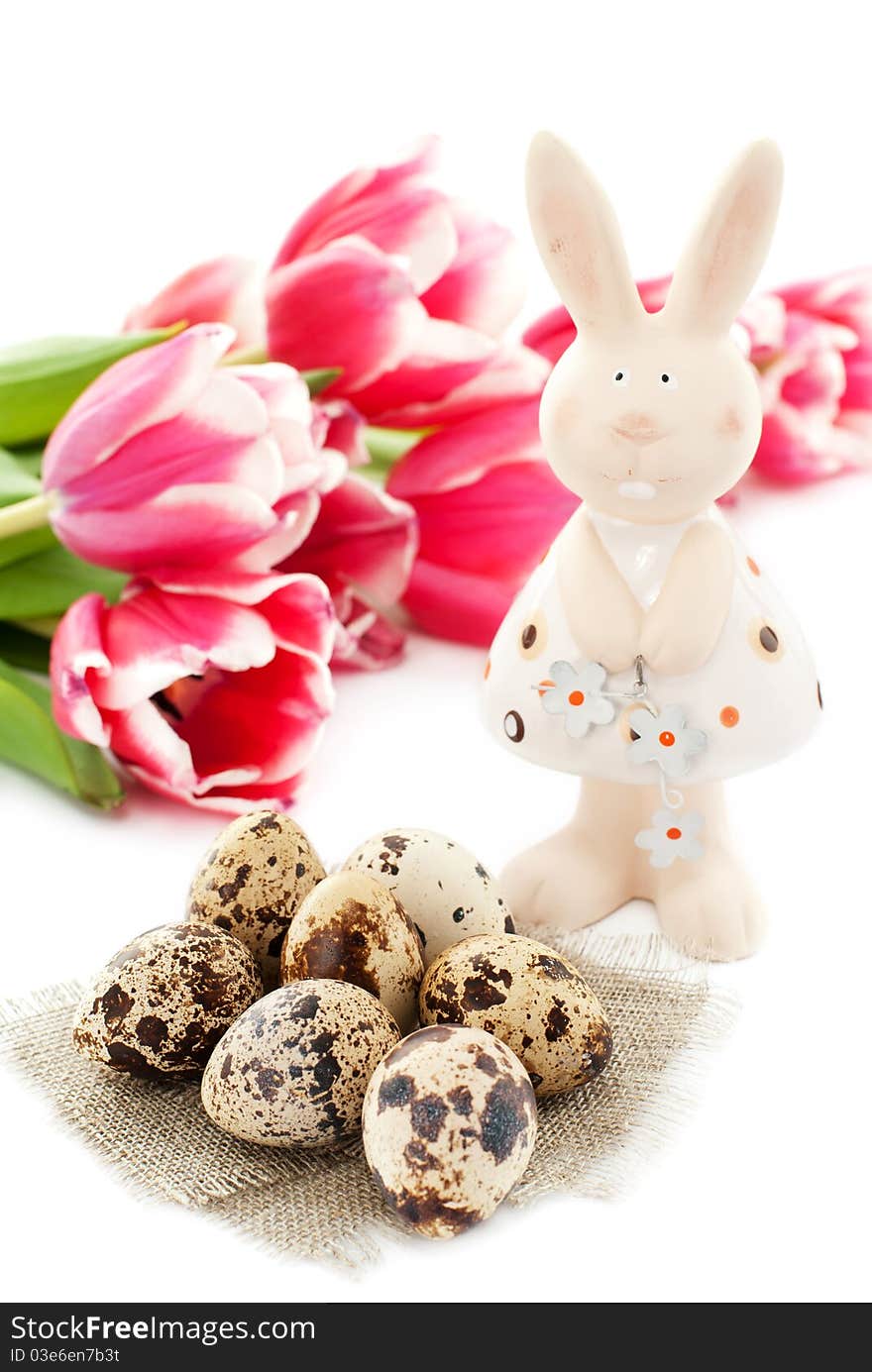 Easter rabbit, quail eggs and tulips on white background. Easter rabbit, quail eggs and tulips on white background