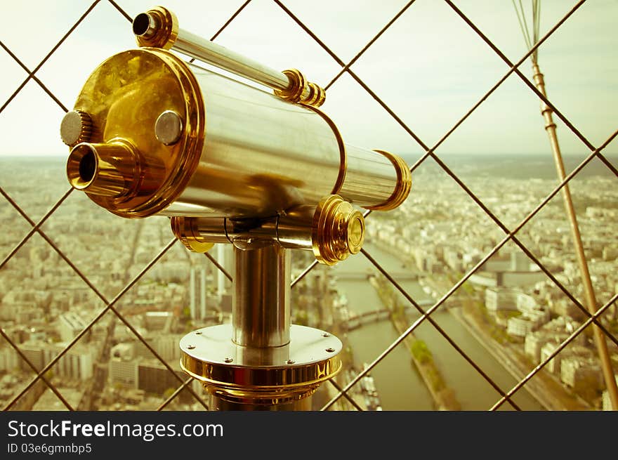 Binocular in Eiffel Tower and view of Paris