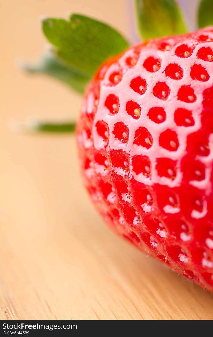 Closeup of ripe strawberry on wooden background. Closeup of ripe strawberry on wooden background