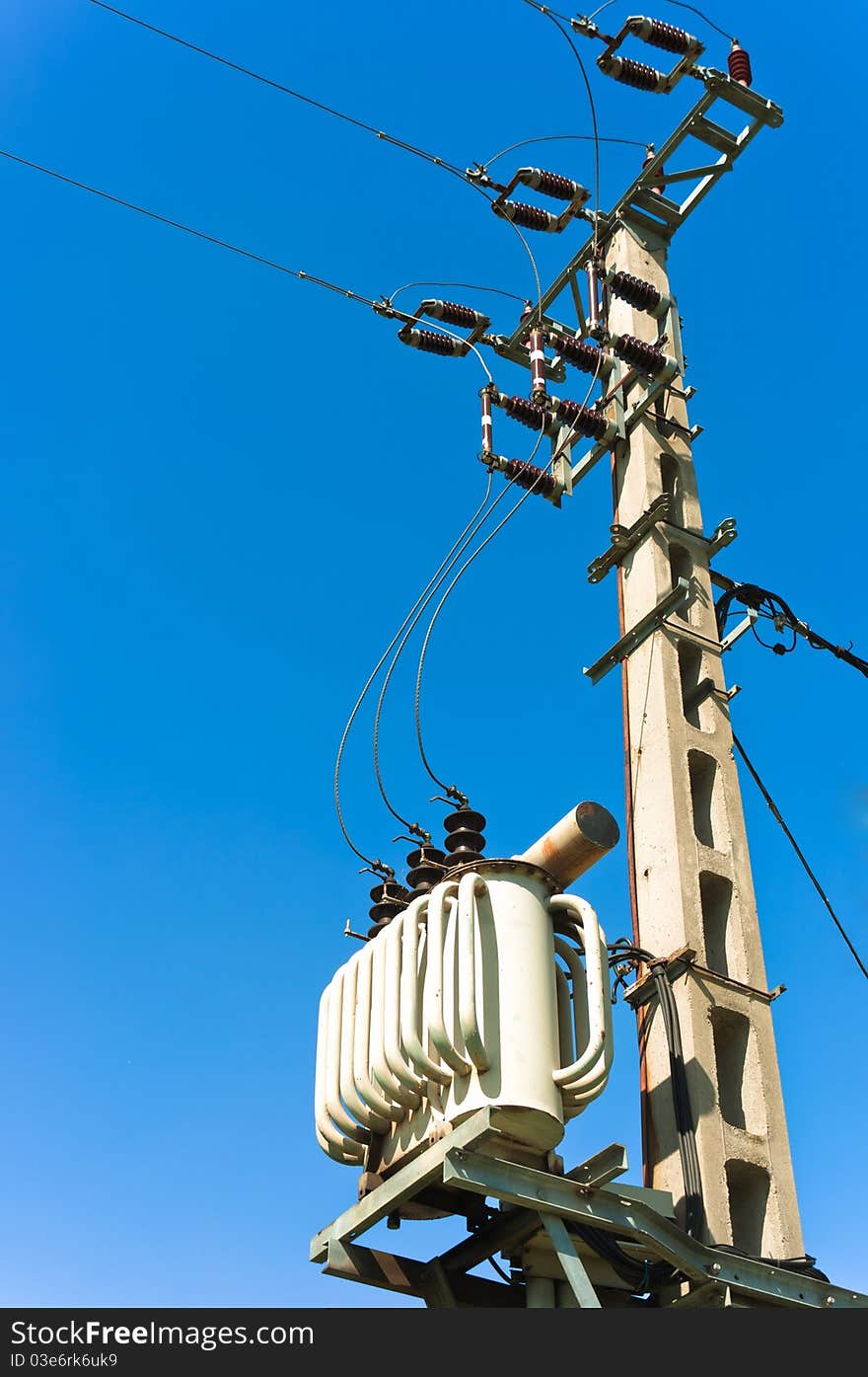 Power line against blue sky with electric cables