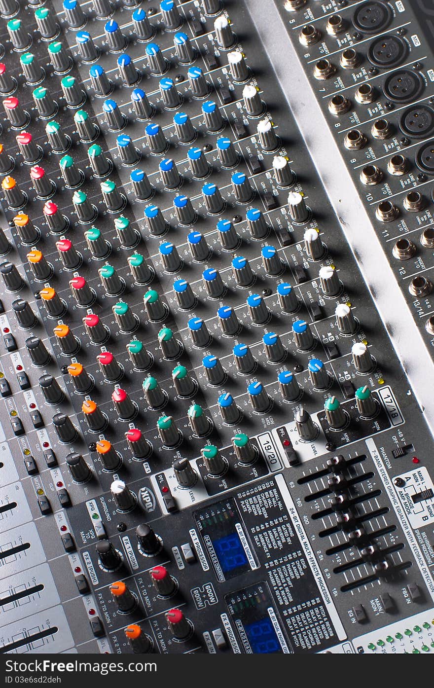 Sliders and buttons of a Sound Mixer with blurry background