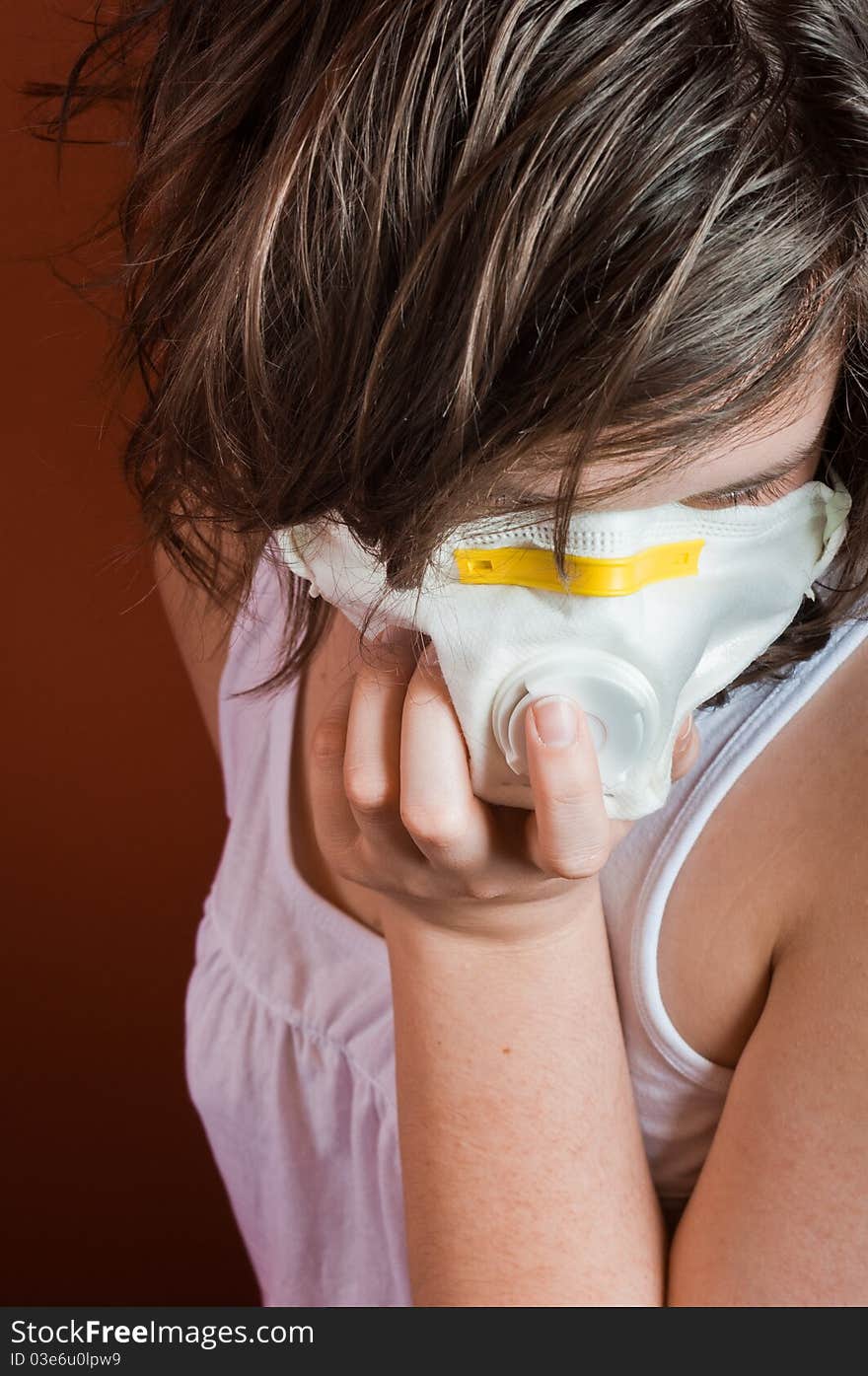 Girl wearing protective mask against red background