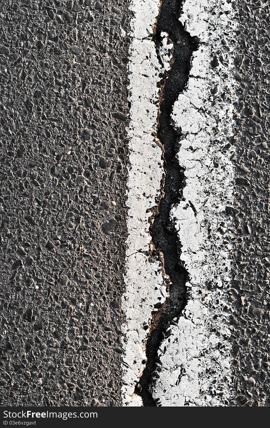 Cracked Asphalt Road Surface With Line