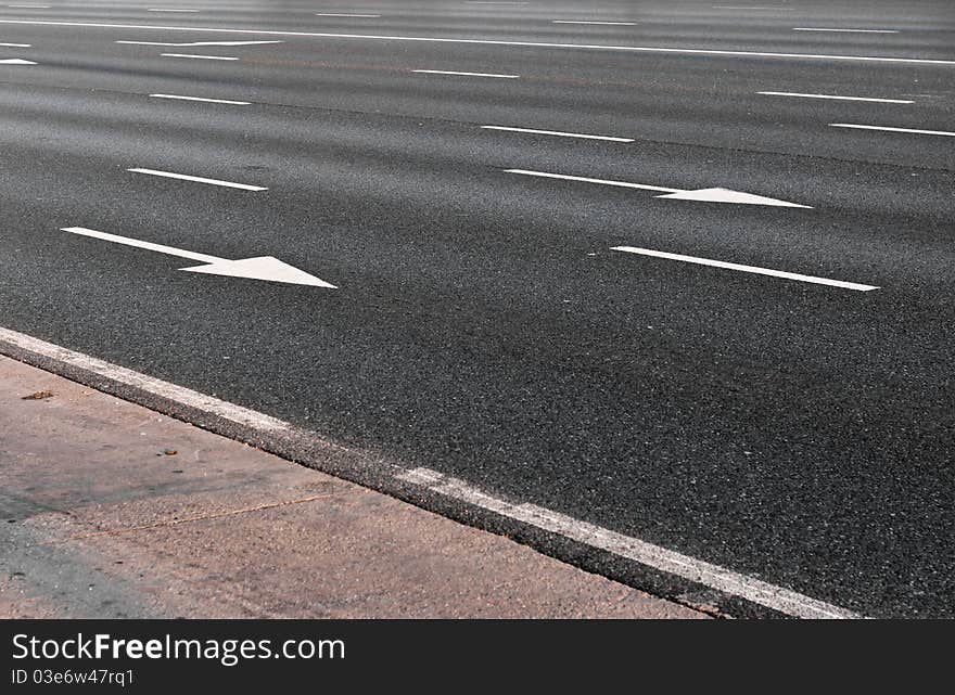 Arrow direction on asphalt with evening light