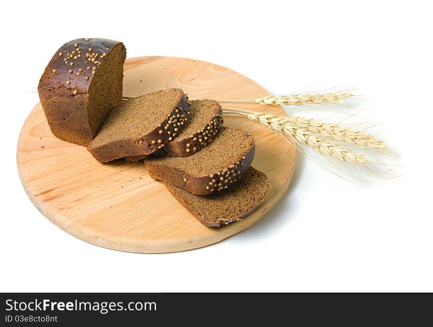 Slices of bread and shafts of wheat on a white background