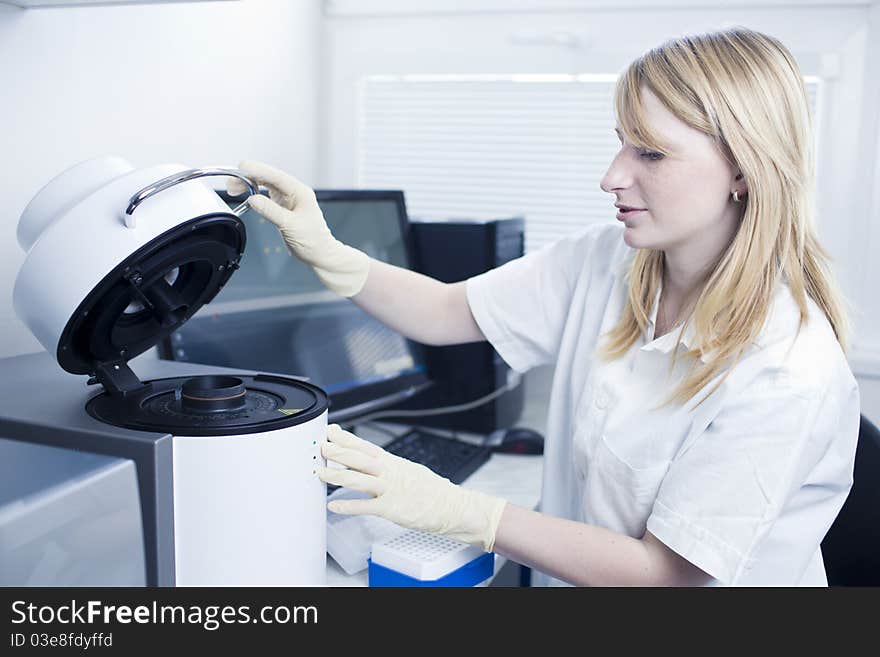 Portrait of a female researcher doing research in a lab (color toned image; shallow DOF)