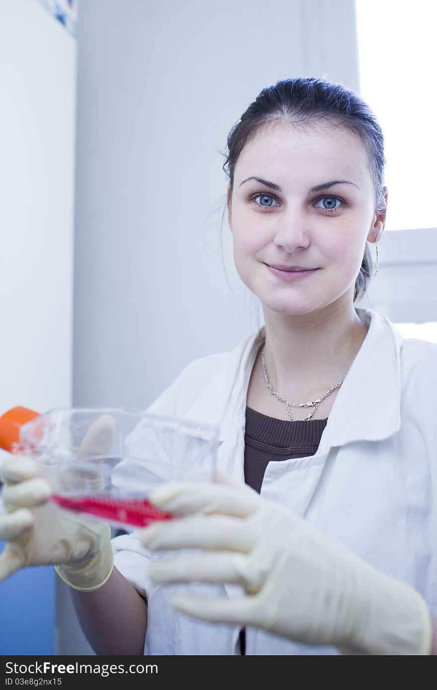 Portrait of a female researcher doing research in a lab (color toned image; shallow DOF). Portrait of a female researcher doing research in a lab (color toned image; shallow DOF)