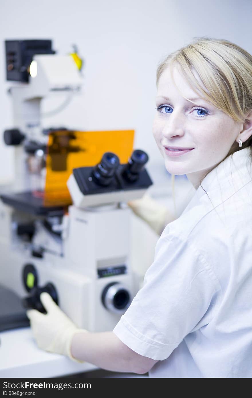 Portrait of a female researcher doing research in a lab (color toned image; shallow DOF). Portrait of a female researcher doing research in a lab (color toned image; shallow DOF)