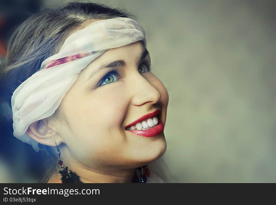 Beautiful smiling face of woman close-up in profile - white background. Beautiful smiling face of woman close-up in profile - white background