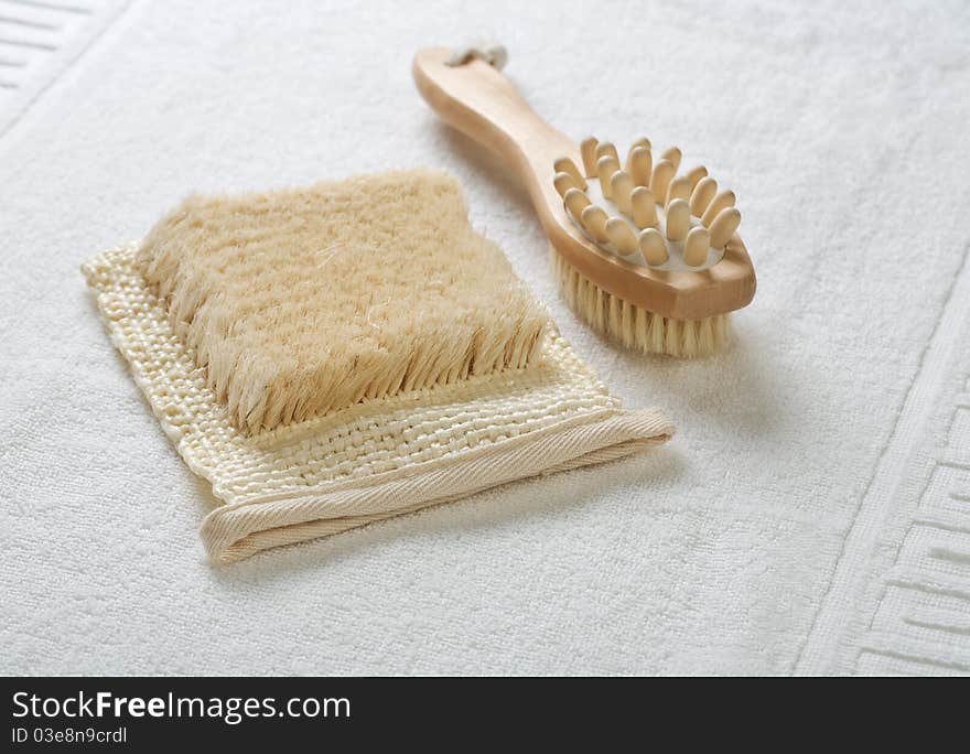 Close up view on the bast and massager on white towel. Close up view on the bast and massager on white towel