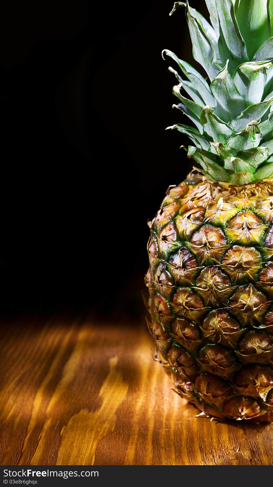 Studio shot ananas on the old brown wooden board with copy space. Studio shot ananas on the old brown wooden board with copy space