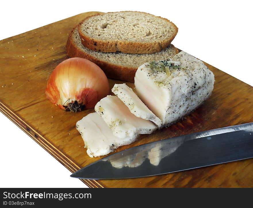 Bacon, onion, chunks of bread and a knife on a cutting board, white background