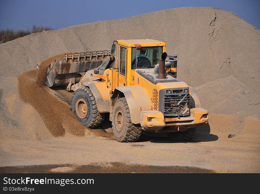 Bulldozer at work. against the blue sky