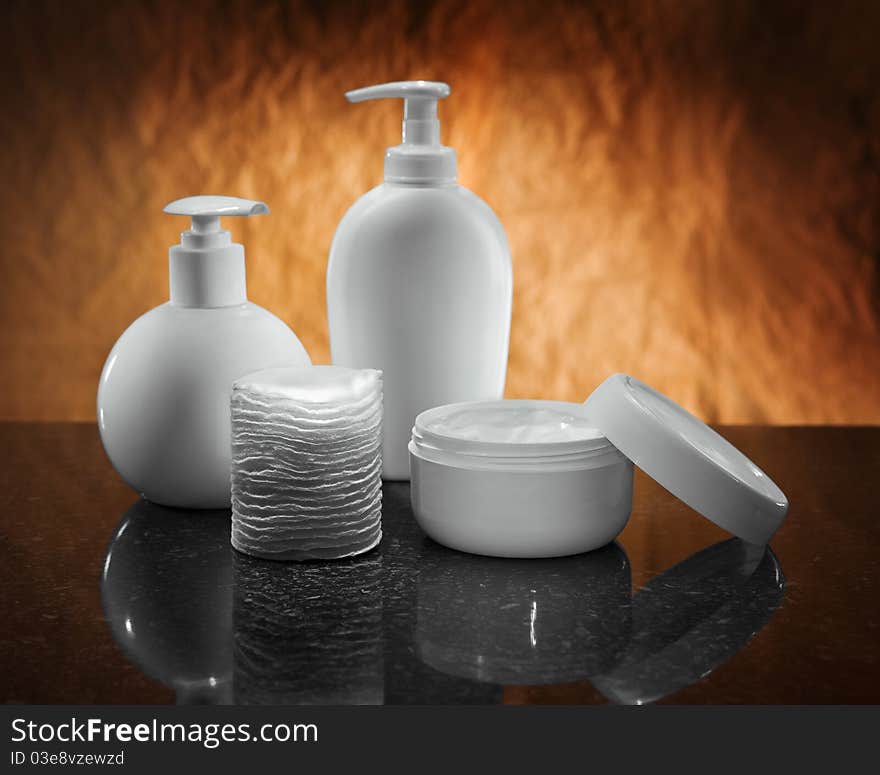 White care bottles on black and brown background. White care bottles on black and brown background