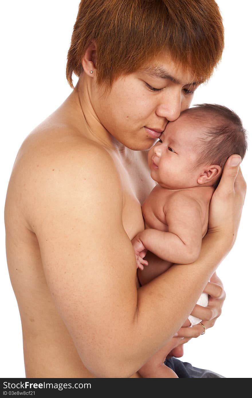 A oriental father holding on to his new baby showing his love and affection on his face. A oriental father holding on to his new baby showing his love and affection on his face.