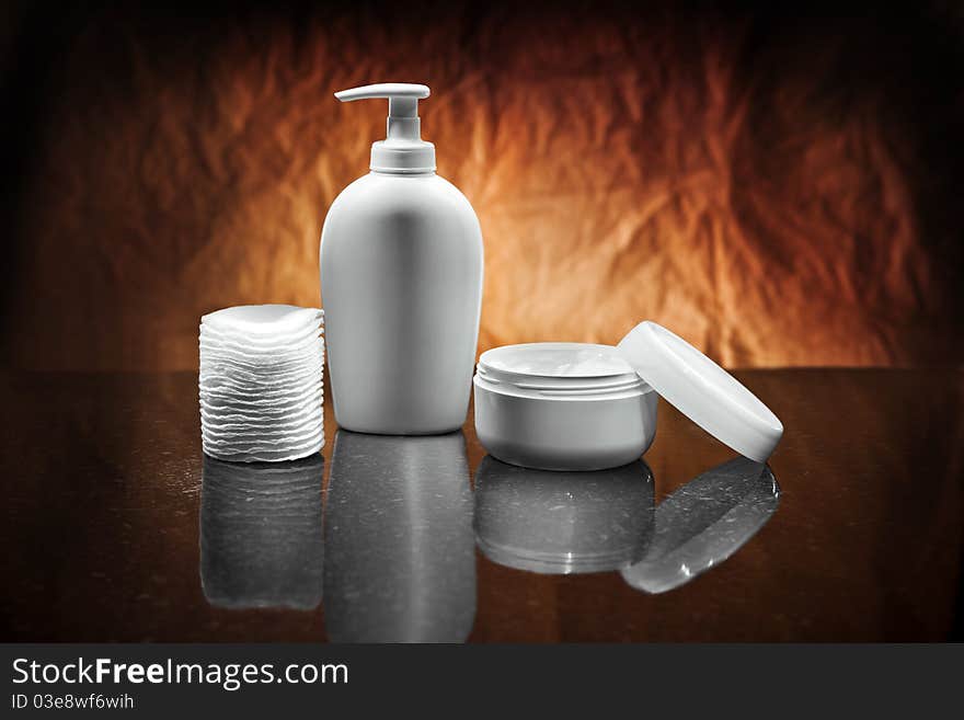 White skincare items on dark background