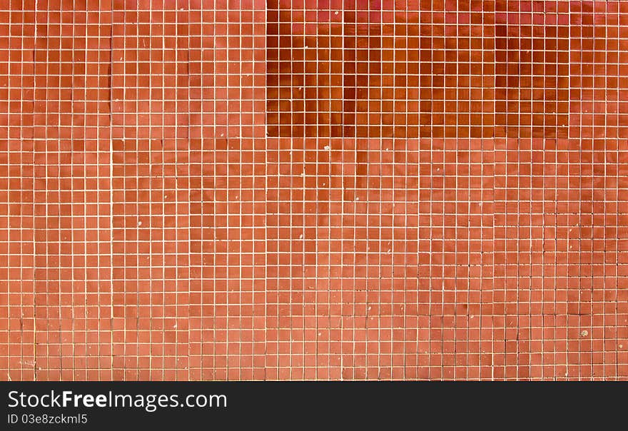 Building wall revetted with a red small tile. Building wall revetted with a red small tile