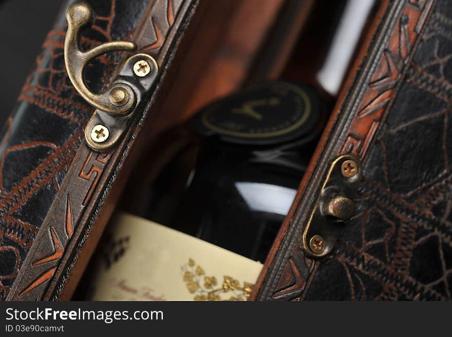 Cognac bottle in wooden case background