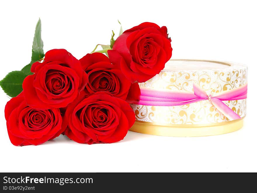 Beautiful red roses and present round boxes with candle with ribbon isolated on the white. Beautiful red roses and present round boxes with candle with ribbon isolated on the white.