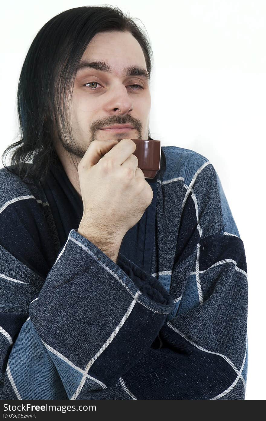 Sleepy man in housecoat with little cup of coffee