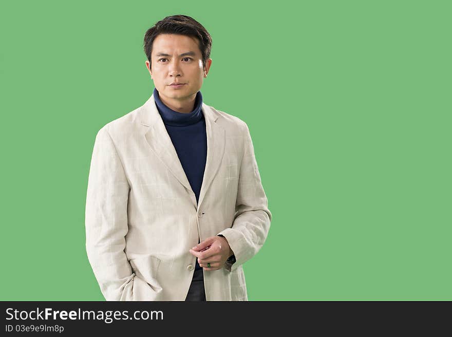 Studio shot of a Chinese man with green back. Studio shot of a Chinese man with green back