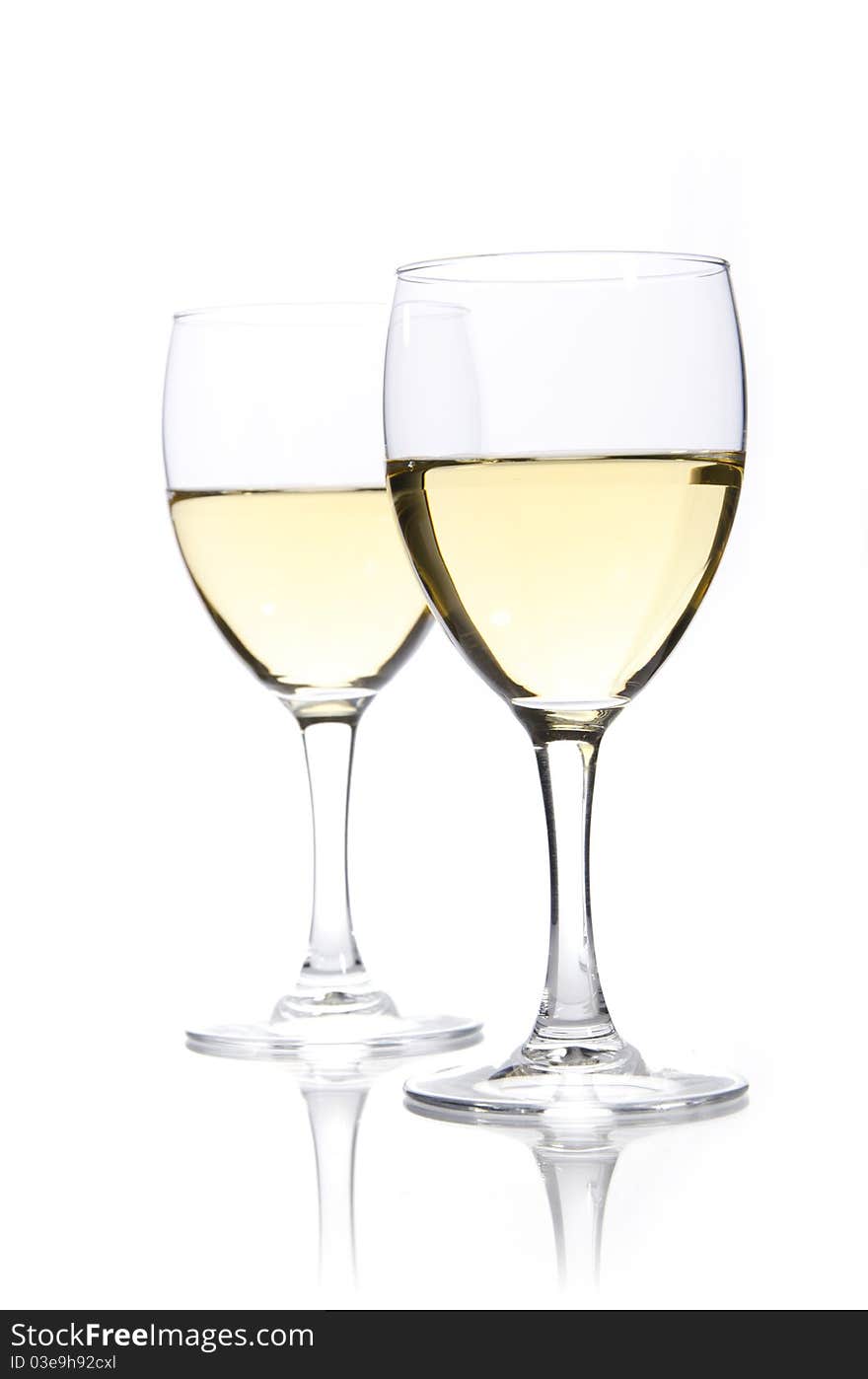 Two glasses of white wine on a white background. Two glasses of white wine on a white background