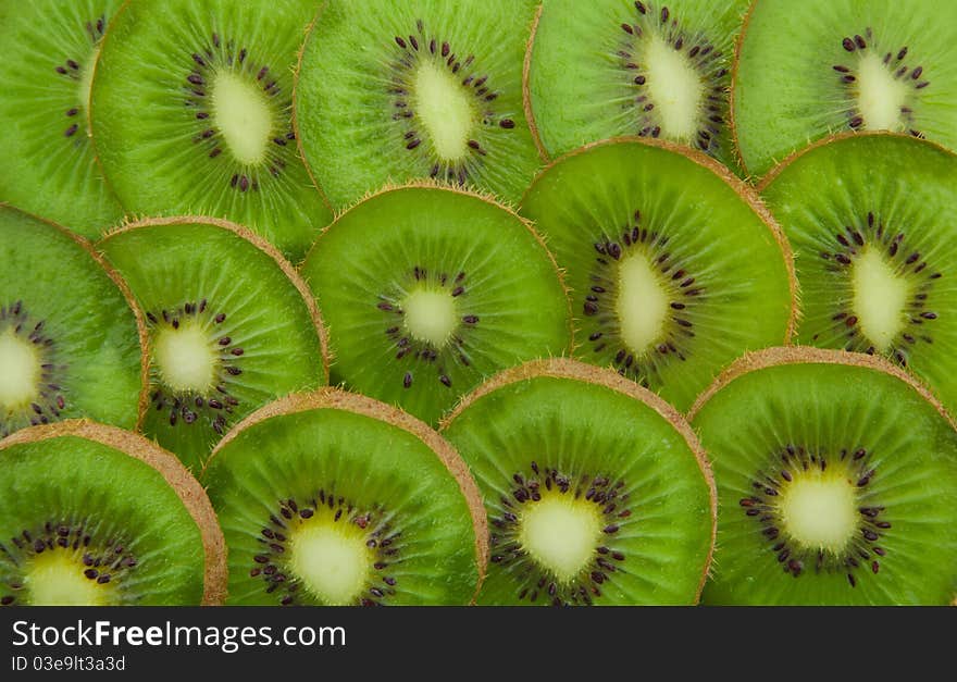 Close-up of kiwi slices forming background