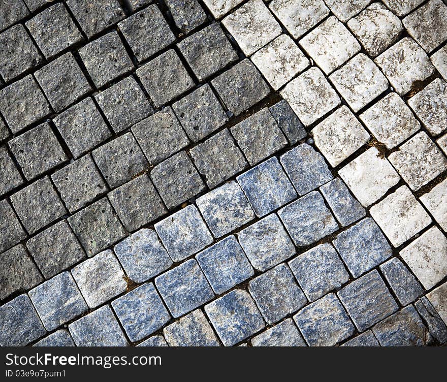 Abstract background of grungy old gray cobblestone or granite pavement