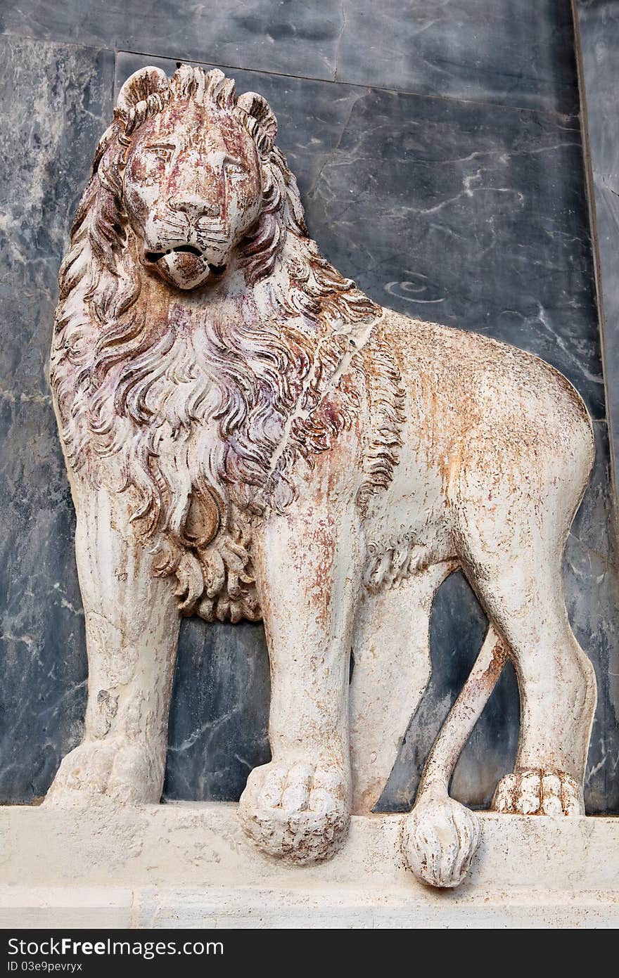 The Lion, ancient marble bas-relief, detail on building wall in Venice, Italy. The Lion, ancient marble bas-relief, detail on building wall in Venice, Italy