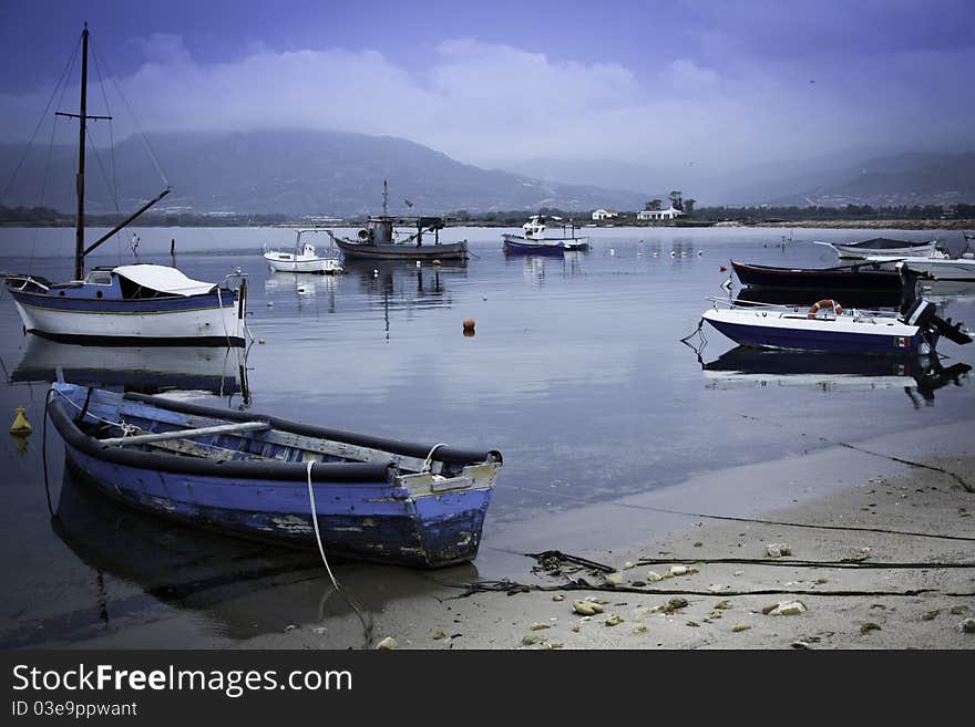 Romantic beautifully picturesque harbor captured late in the afternoon with small boats on a blue sky. Romantic beautifully picturesque harbor captured late in the afternoon with small boats on a blue sky.