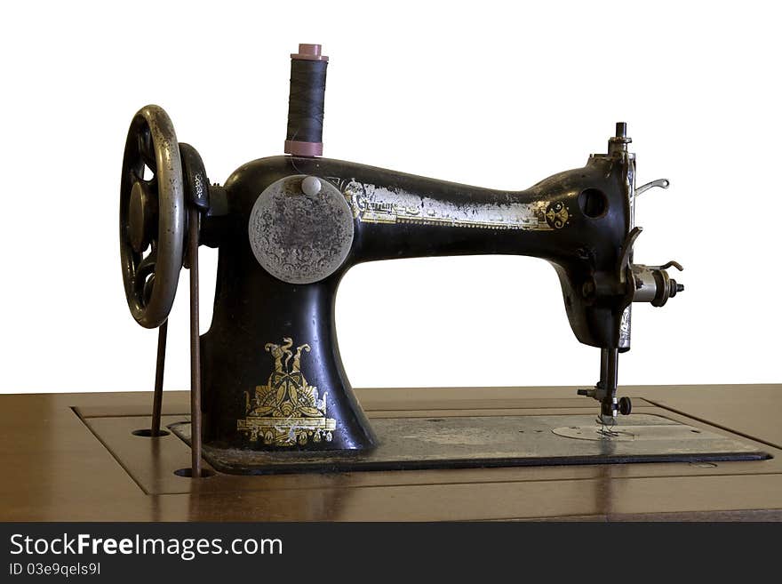 Antique sewing machine. Taken on white background. Antique sewing machine. Taken on white background.