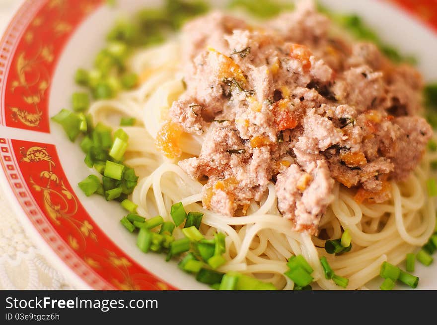 Italian pasta with tasty stuffing and spring onions on a beautiful plate. Italian pasta with tasty stuffing and spring onions on a beautiful plate