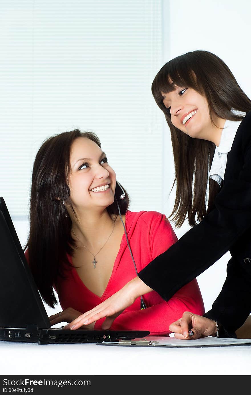 Two beautiful girls working in the office