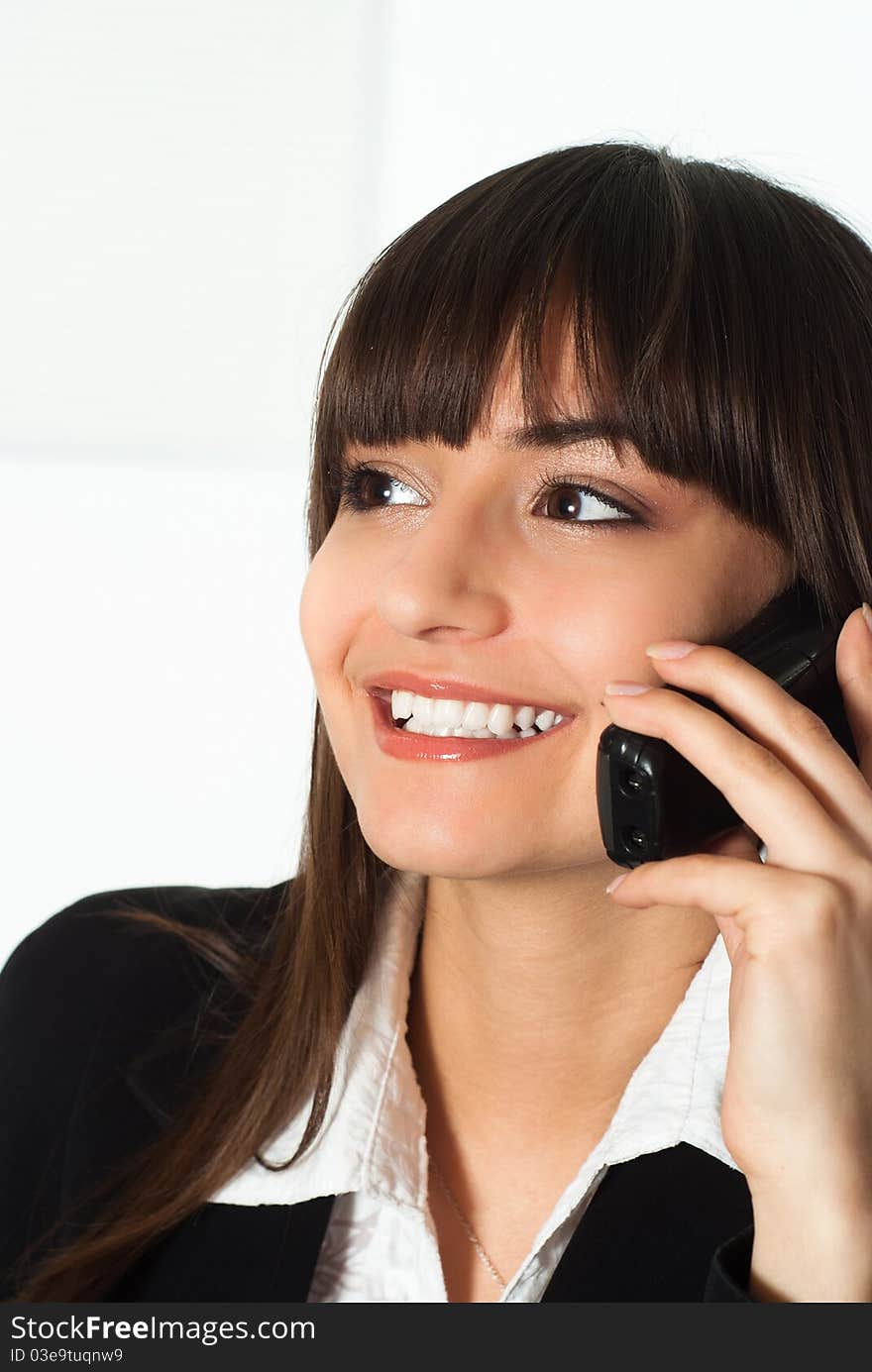 Nice girl in a business suit talking on the phone. Nice girl in a business suit talking on the phone